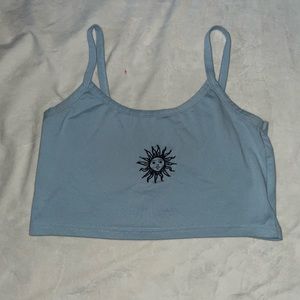Blue tank top, sun stitched print in the middle.